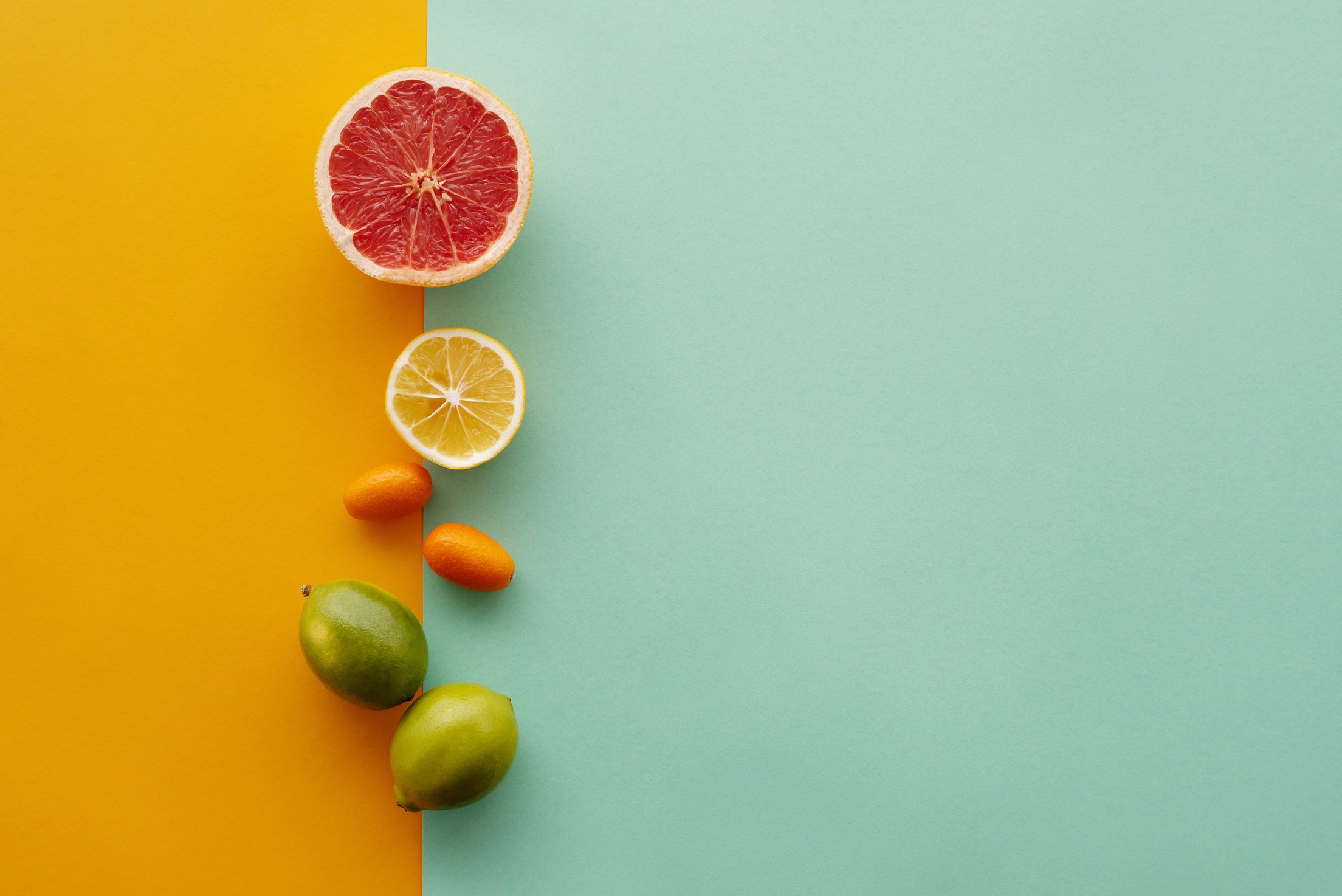 Citrus Fruits on Green and Yellow Surface